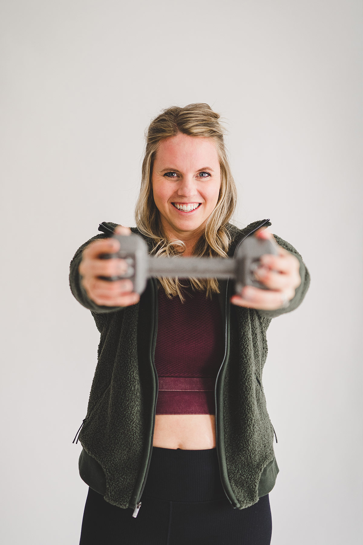 happy blonde female lifting weights