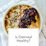 a bowl of oatmeal topped with blueberries and pecans