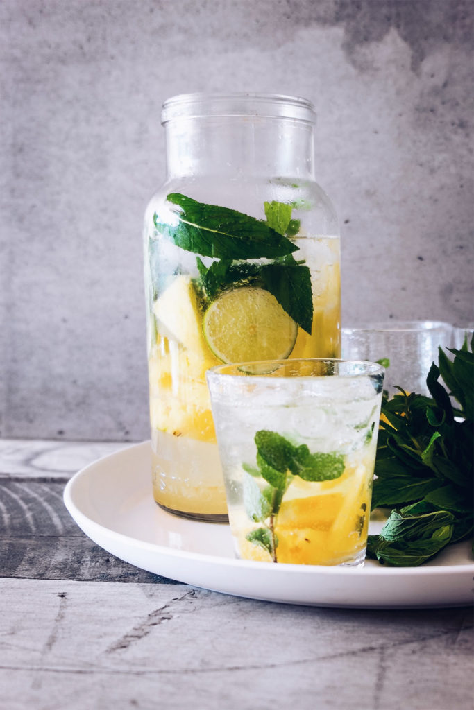 pitcher of water with lemons and basil