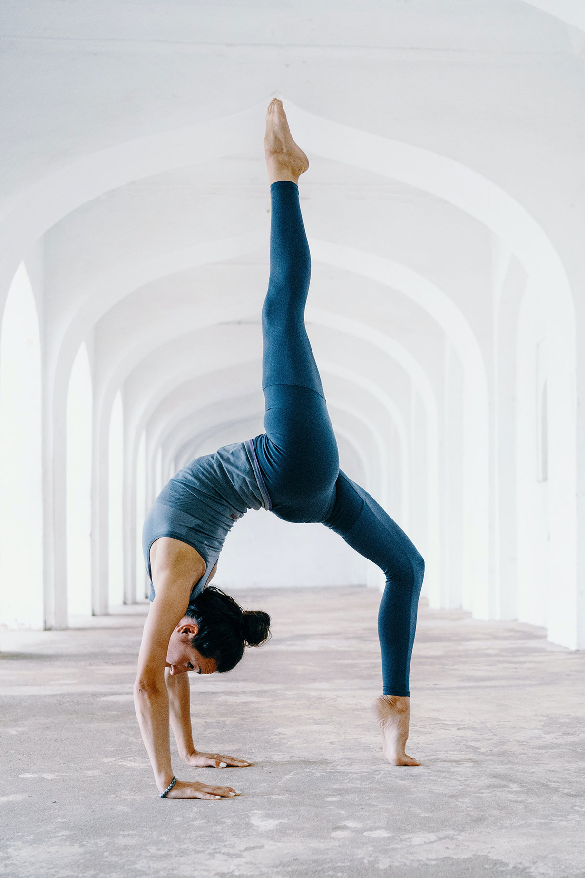 woman doing a yoga pose with blue outfit