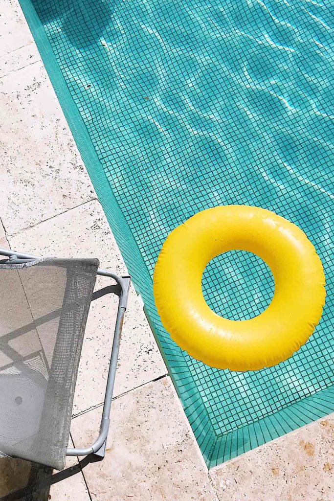 yellow pool floaty in swimming pool