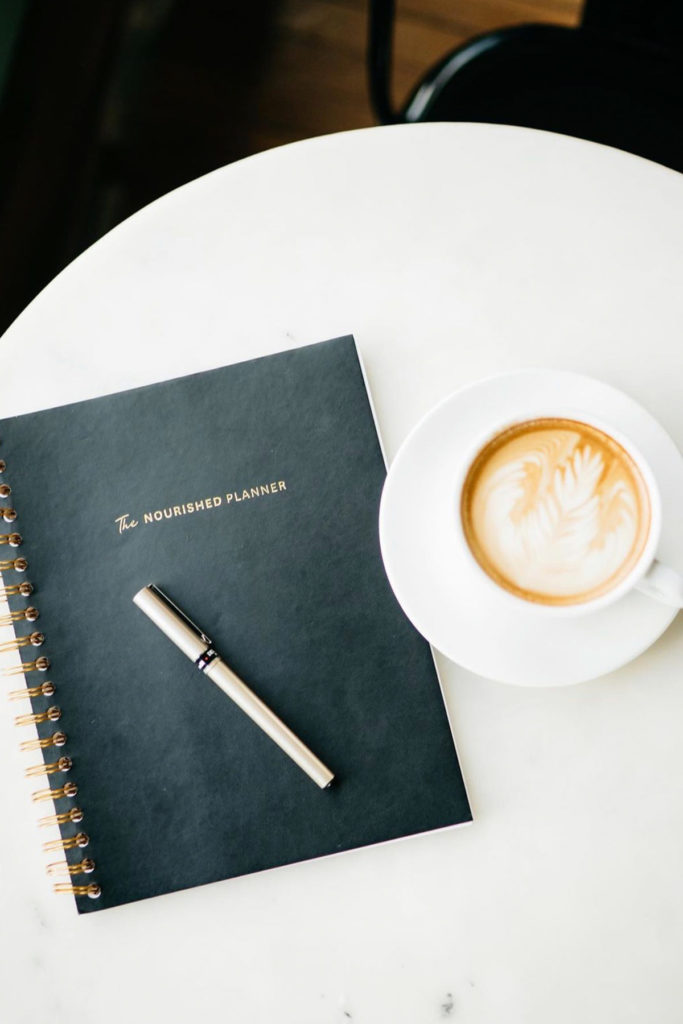 nourished planner with coffee