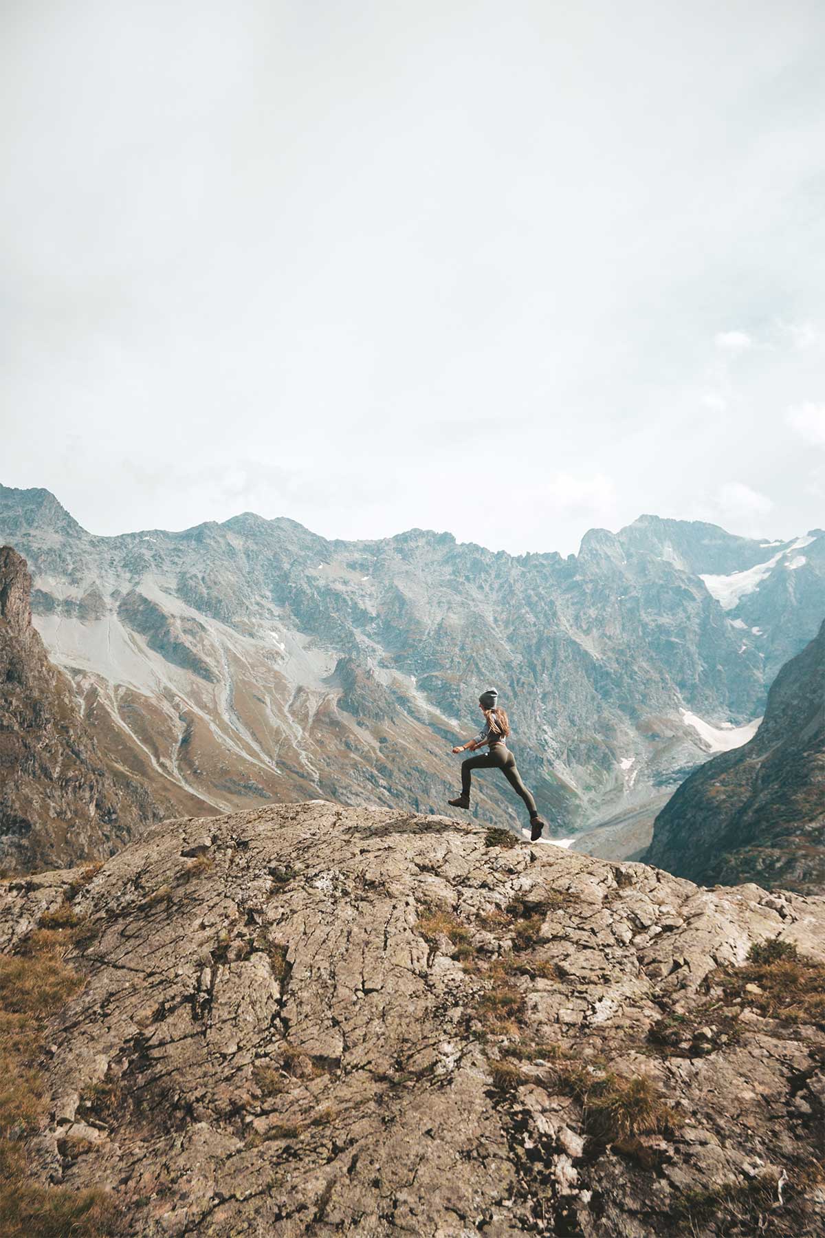 Girl on mountain climbing mountain backdrop